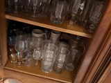 a cabinet with a lot of glasses on top of it