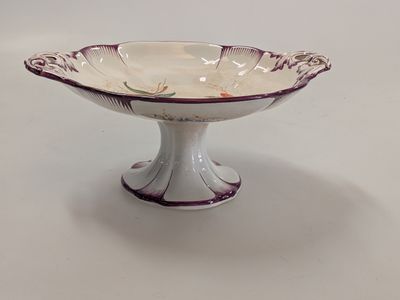 a white and purple bowl on a white table