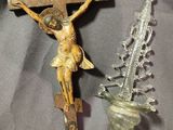 a crucifix and a glass vase on a table