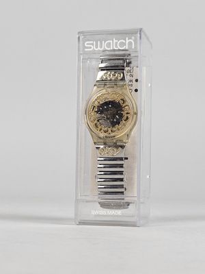 a watch that is in a clear box on a table