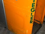 an orange machine with a sign on the side of it