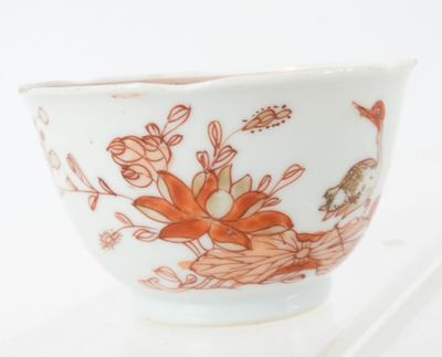 a white bowl with a red and orange floral design on it