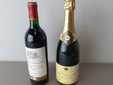 two bottles of wine sitting next to each other on a table