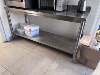 a microwave and a microwave oven sitting on a stainless steel table