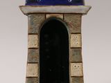 a small blue and white tower with a clock on it