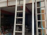 two ladders that are next to each other in a garage