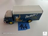 un camion miniature posé sur une table avec un bout de papier