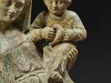 an old statue of a woman holding a child in her lap