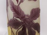 a glass vase with a purple and white design on it