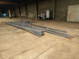 a large pile of steel rods in a warehouse