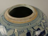 a blue and white vase sitting on a table