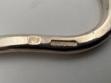 a close up of a metal object on a white surface