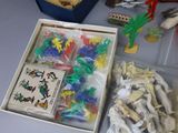 a box full of assorted plastic toys on a table