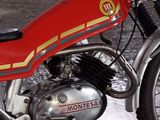 a red motorcycle that is parked in a garage
