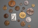 Plusieurs pièces de monnaie différentes sont disposées en cercle sur une surface grise.