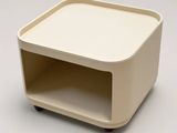 a small white table with a shelf on it