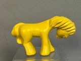 a yellow toy horse that is standing on a clear surface