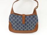 a blue and brown guccissi bag with a brown strap