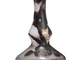 a black and white vase sitting on a white surface