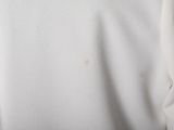 a picture of a white shirt with a small spot on the chest
