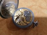 a pocket watch that is sitting on a table
