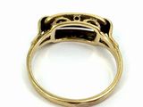 a close up of a gold ring with a black stone