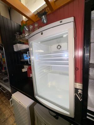 a white refrigerator sitting in a kitchen next to a refrigerator freezer