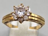 a picture of a gold ring with a white diamond