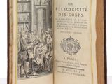 an open book with a drawing of a man sitting at a table in front of a group of people