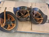 three bowls of food sitting on a cart in a warehouse
