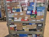 a metal cart with many boxes on it in a warehouse