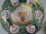 a plate with a floral design on it next to a stack of plates
