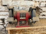 a red machine that is sitting on a wooden table