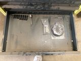 a drawer with tools in it on the floor
