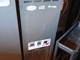 two refrigerators sitting next to each other in a room