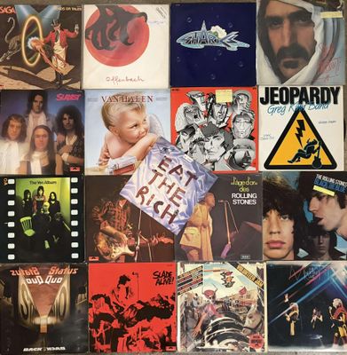 many different album covers on the wall of this room