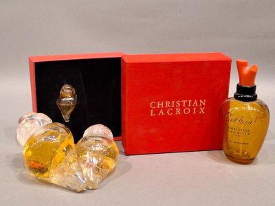 two bottles of perfume sitting next to each other in a red box