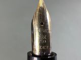 close up of a fountain pen with the tip of the nib resting on the tip of the tip of the nib