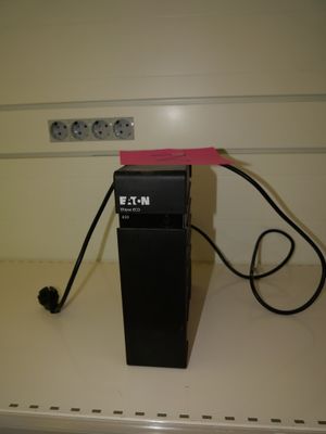 a clock that is on top of a shelf in a room