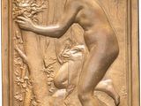 an image of a bronze plaque depicting a woman and a dog