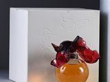 bottles of perfume sitting on a table next to a box
