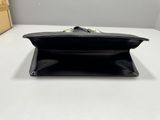 a black purse sitting on top of a table next to a box