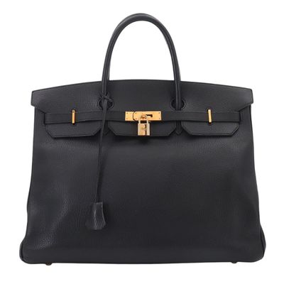 a black leather handbag with a gold lock on the handle