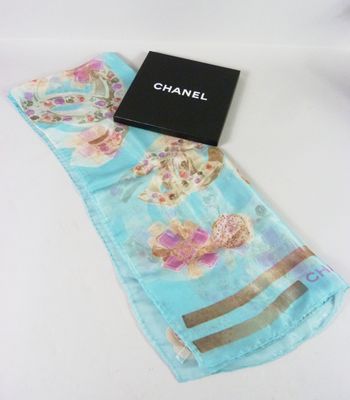 a close up of a scarf with a box on a table