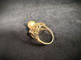 a close up of a gold ring on a black surface