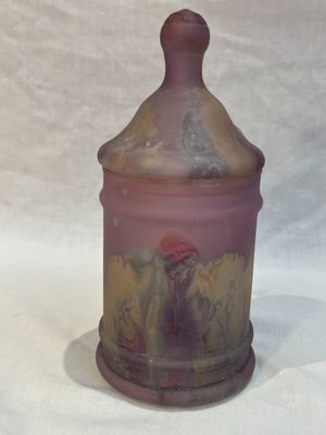 purple and yellow glass jar with a lid on a white surface