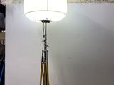 a lamp that is on a tripod in a room