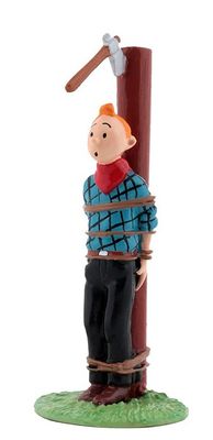 figurine of a man with a hammer on top of a pole