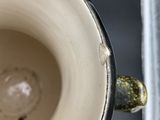 a close up view of a coffee cup with a spoon in it