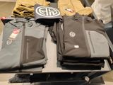a lot of clothing on a table in a store